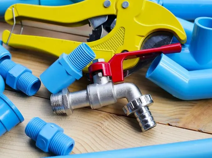 Blue PVC pipe fittings, PVC cutter and steel valve