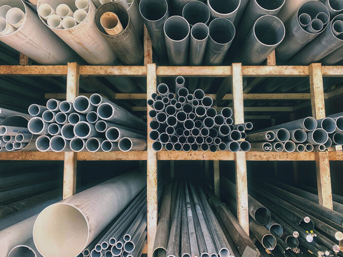 PVC ans steel pipe on shelves in a plumbing supply warehouse