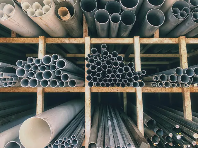 PVC ans steel pipe on shelves in a plumbing supply warehouse